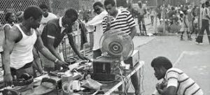 Young Black kids gathered around DJ decks at a block party